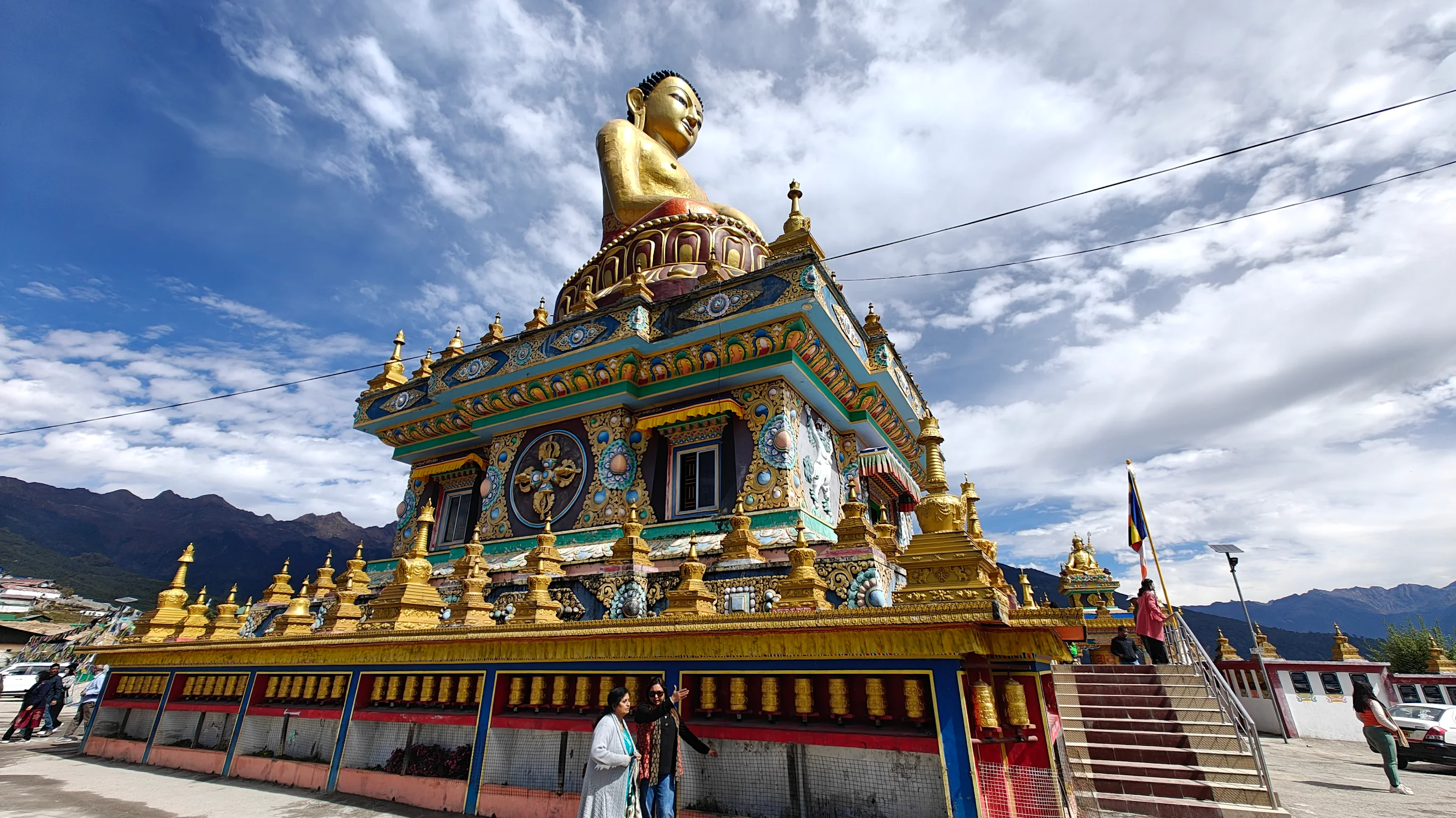 Monks in maroon robes walking through the courtyard of Tawang Monastery, the largest monastery in India